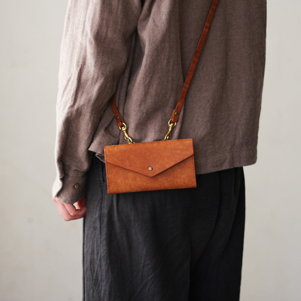 ftiPhoneケースストラップ付きキャメルの着用画像